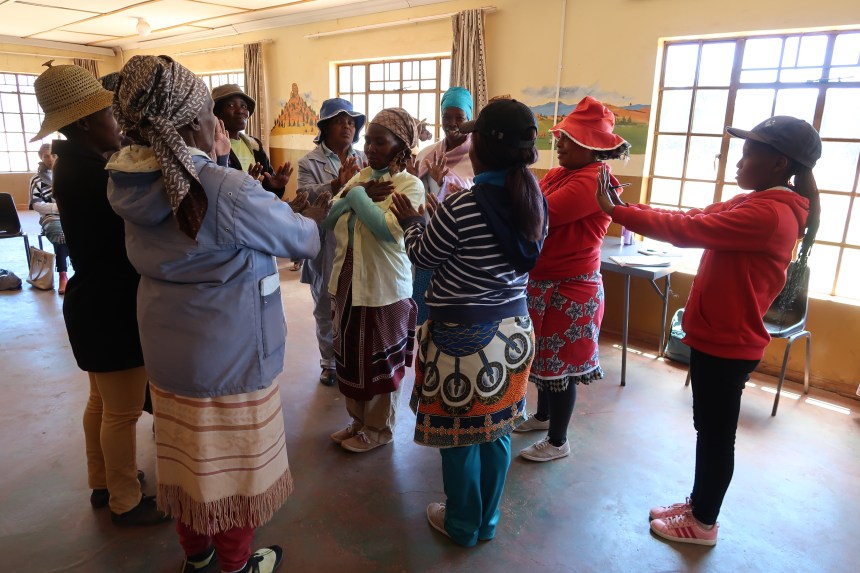 women stand in a circle ready to conduct a trust exercise in the Malealea Development Trust's HIV/AIDs support group, Lesotho, Southern Africa