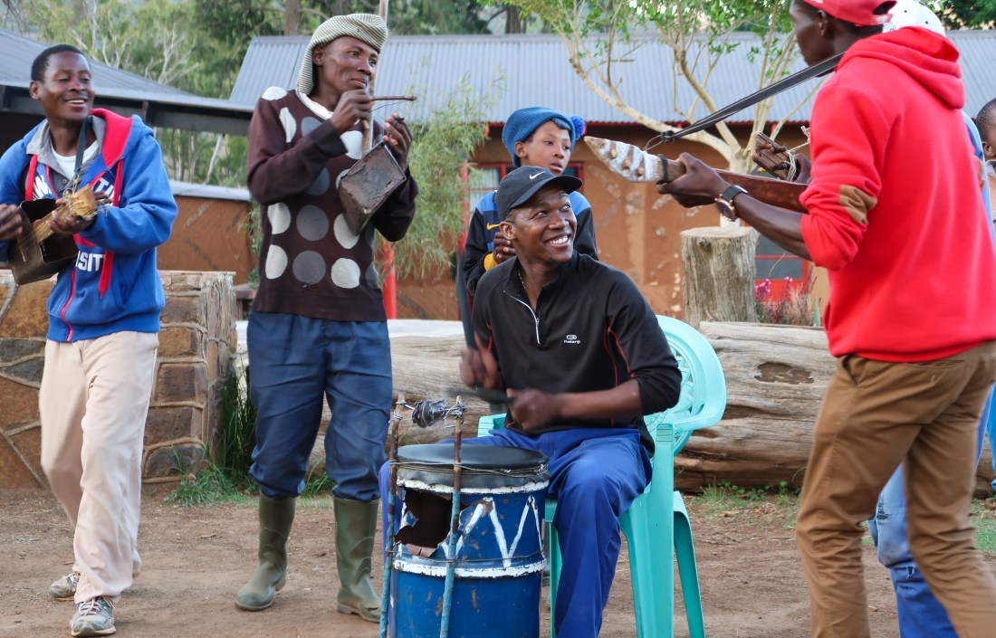 a group of musicians perform outside at the Malealea Lodge on homemade traditional Basotho instruments, photo by Kelly Benning