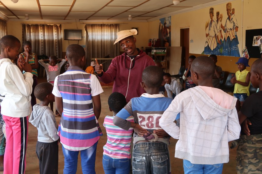MDT Field Worker Tsotang Monyane addresses a group of kids, explaining how to do an exercise in Lesotho, Southern Africa