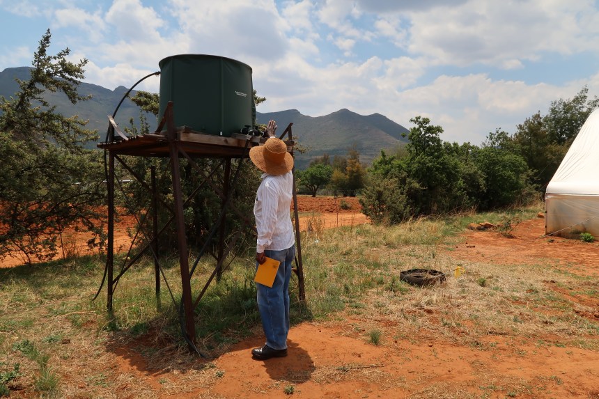 Albert Musi, a farmer, checks the pressure of one of his water tanks that irrigates his fields, in front of the Maloti Mountains of Malealea, Lesotho, Southern Africa